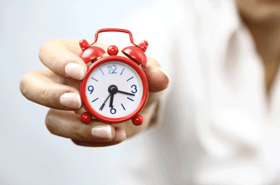 man holding alarm clock